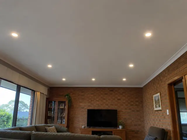Living room with recessed LED downlights in a brick home interior in New Lambton Heights